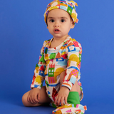 Baby long sleeve bodysuit by Halcyon Nights featuring a whimsical castle of dreams design for newborns aged 0-3 months.