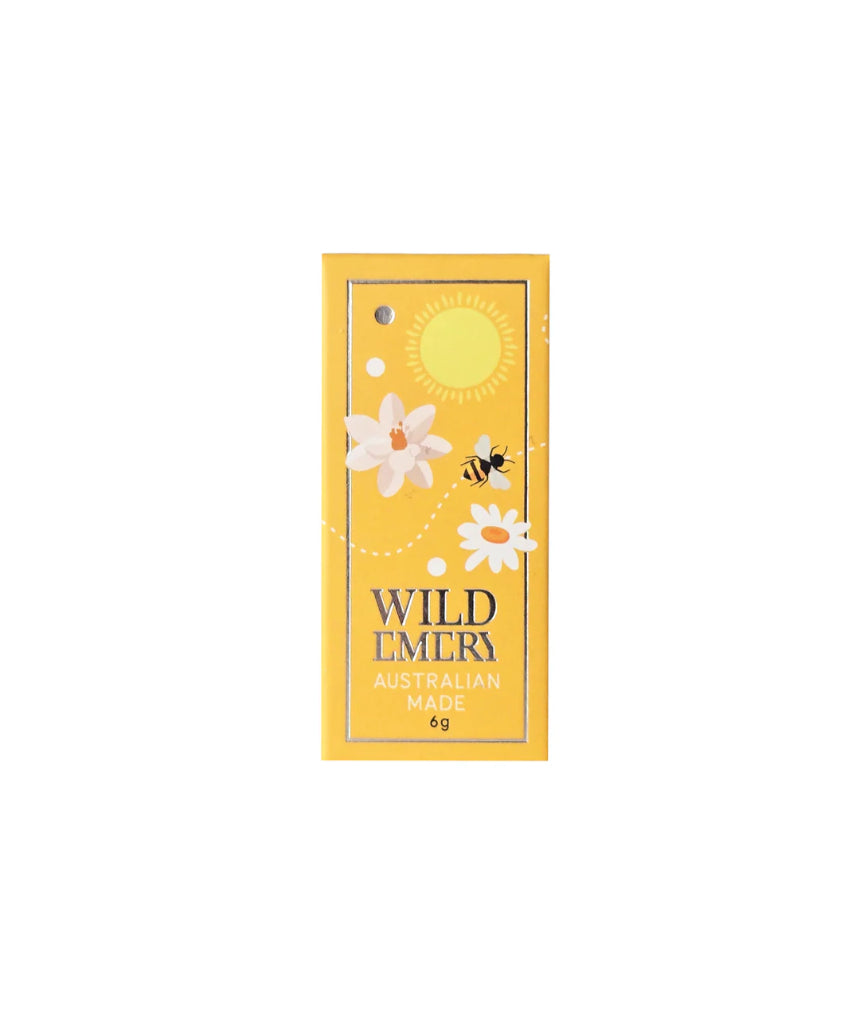 Wild Emery Honey Mini Lip Balm in a sleek lipstick tube with honey-colored packaging, designed for nourishing lip care.