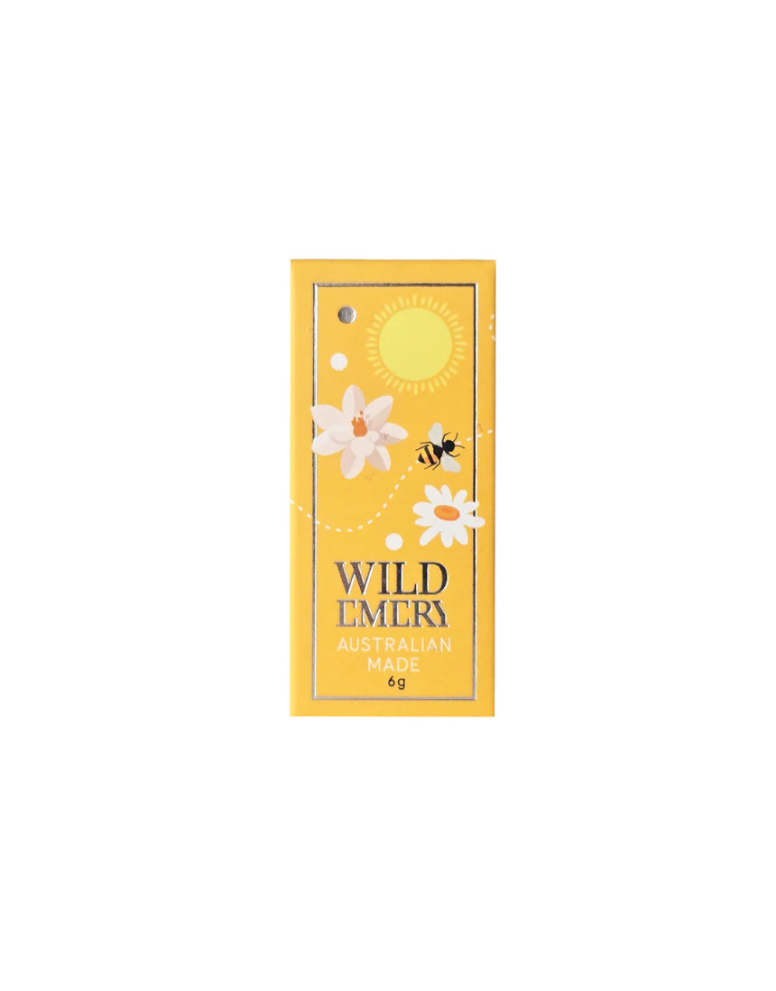 Wild Emery Honey Mini Lip Balm in a sleek lipstick tube with honey-colored packaging, designed for nourishing lip care.