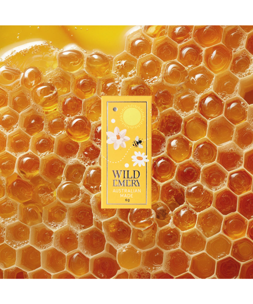 Wild Emery Honey Mini Lip Balm in honey-colored lipstick tube, featuring natural honey-inspired packaging.