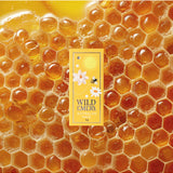 Wild Emery Honey Mini Lip Balm in honey-colored lipstick tube, featuring natural honey-inspired packaging.