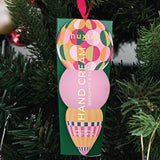 Green Huxter Adorned Christmas Hanging Hand Cream with festive packaging, perfect for holiday gift-giving.
