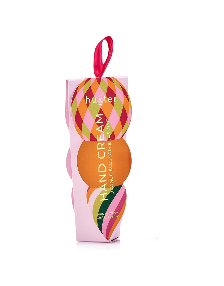 Huxter Adorned Christmas Hanging Hand Cream in soft pink with festive decorative wrapping and hanging ribbon.