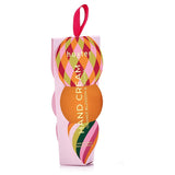 Huxter Adorned Christmas Hanging Hand Cream in soft pink with festive decorative wrapping and hanging ribbon.