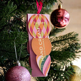 Huxter Adorned Christmas Hanging Hand Cream in soft pink, featuring decorative holiday packaging and a festive design.