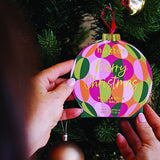 Huxter Adorned Christmas Hanging Lip Balm in green, featuring festive packaging with holiday-themed design and branding.