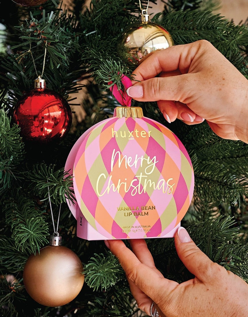 Huxter Adorned Christmas Hanging Lip Balm in soft pink, featuring festive design and packaging, ideal for holiday gifting and skincare.