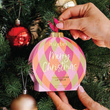 Huxter Adorned Christmas Hanging Lip Balm in soft pink, featuring festive design and packaging, ideal for holiday gifting and skincare.