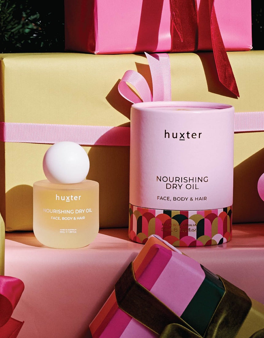 Huxter Adorned Christmas Nourishing Dry Oil 50ml bottle with elegant label and clear dropper for body moisturizing.