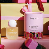 Huxter Adorned Christmas Nourishing Dry Oil 50ml bottle with elegant label and clear dropper for body moisturizing.