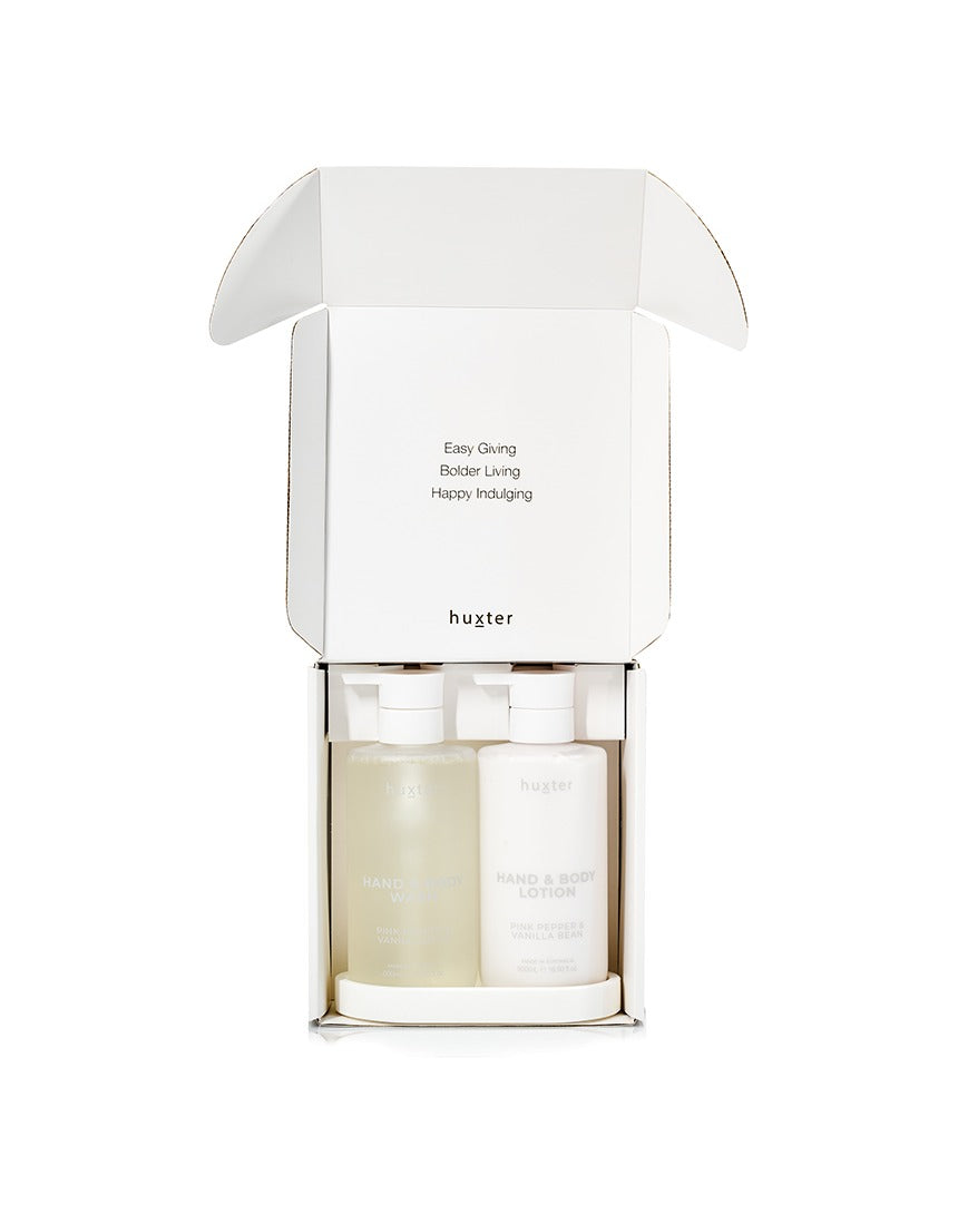 Huxter Adorned Christmas Bath & Body Gift Set with pink pepper and vanilla bean scents, includes wash and lotion bottles.