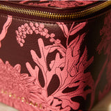 Sage x Clare Delphine Small Vanity Case in Garnet, a stylish cosmetic and toiletry bag with a vibrant red color.