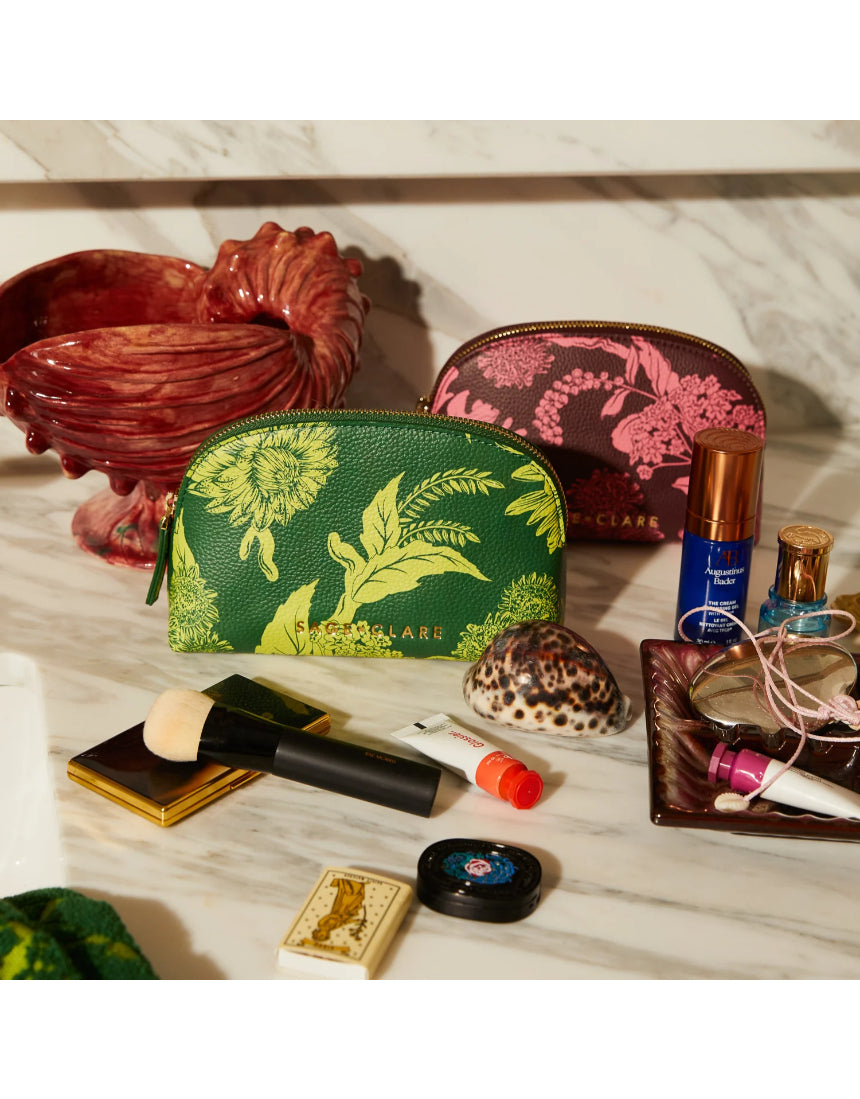 Sage x Clare Delphine Anise cosmetic pouch with floral pattern, fabric exterior, zipper closure, and spacious interior for toiletries.