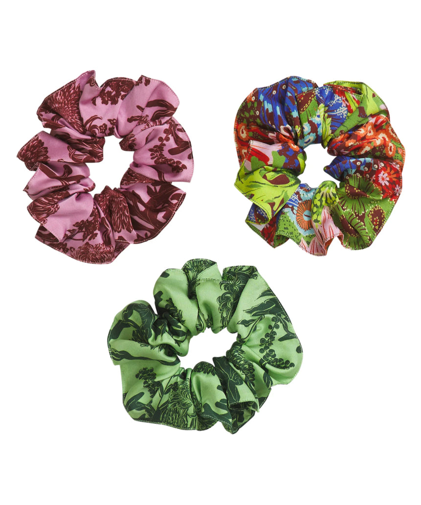 Set of Sage x Clare Delphine silk scrunchies in soft pastel colors, displayed together on a neutral background.