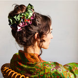 Sage x Clare Delphine silk scrunchie set with multiple soft, colorful fabric scrunchies displayed on a neutral background.