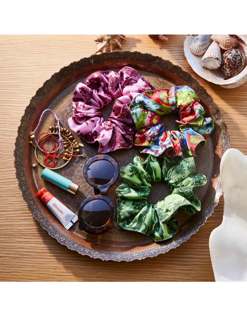 Sage x Clare Delphine silk scrunchie set with three elegant, shiny fabric hair accessories on a neutral background.