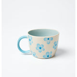 Jones & Co Chino Mug in Daisy Blue with floral pattern, ceramic mug featuring a curved handle and vibrant blue design.