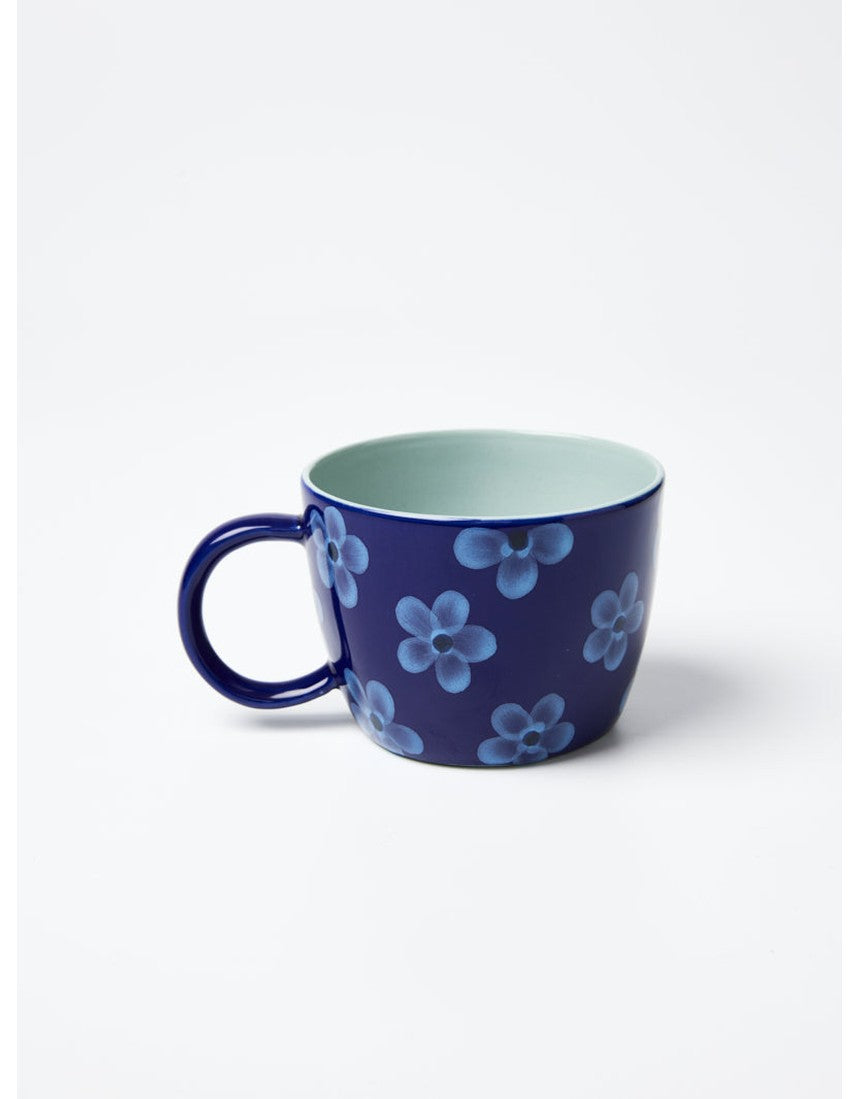 Jones & Co Chino Mug in Daisy Navy featuring a floral design on a ceramic mug with a navy background.