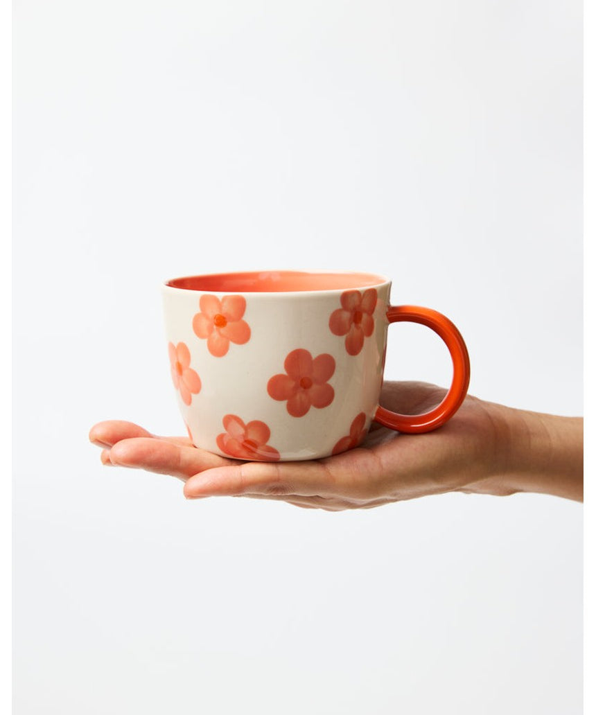 Jones & Co Daisy Peach Chino Mug with floral pattern, ceramic handle, and pastel peach color.