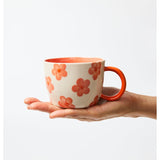 Jones & Co Daisy Peach Chino Mug with floral pattern, ceramic handle, and pastel peach color.