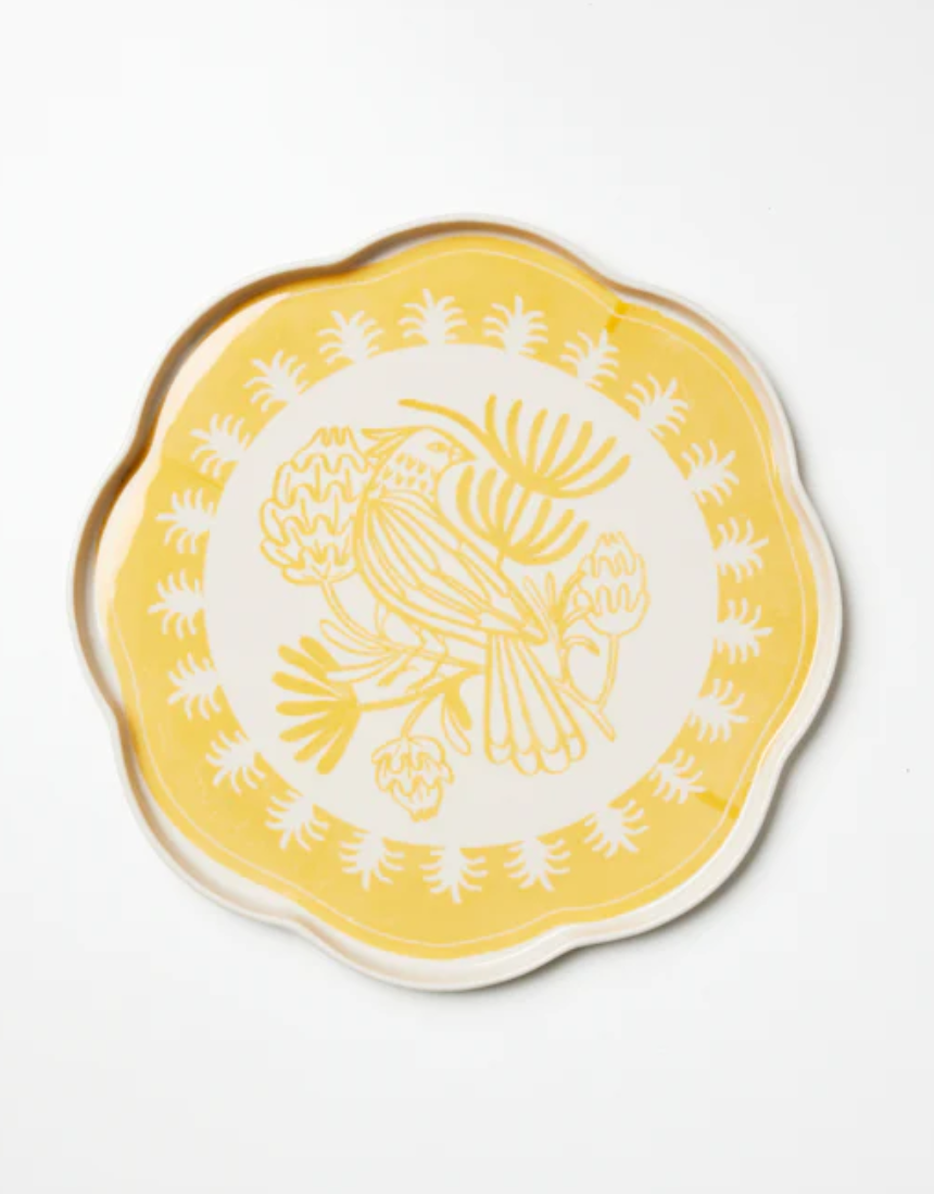 Jones & Co Del Sol bird-shaped ceramic platter in mustard yellow, featuring a detailed bird design.