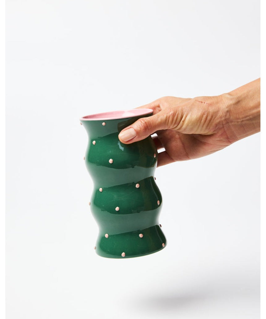 Jones & Co Palma Vase in green with pink dotty pattern, featuring a stylish ceramic design and a rounded shape.
