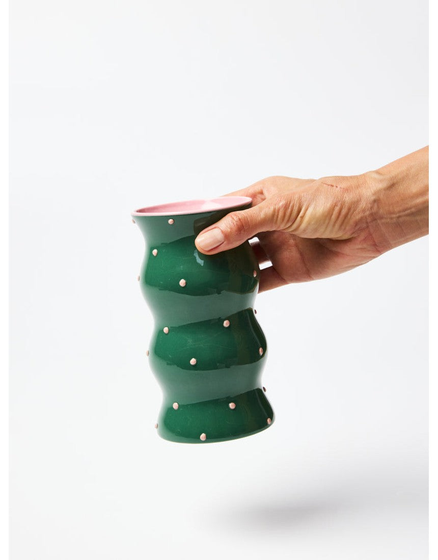 Jones & Co Palma Vase in green with pink dotty pattern, featuring a stylish ceramic design and a rounded shape.