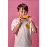 Child playing wooden fruit harmonica by isAlbi, showing a colorful, handcrafted musical instrument for kids.