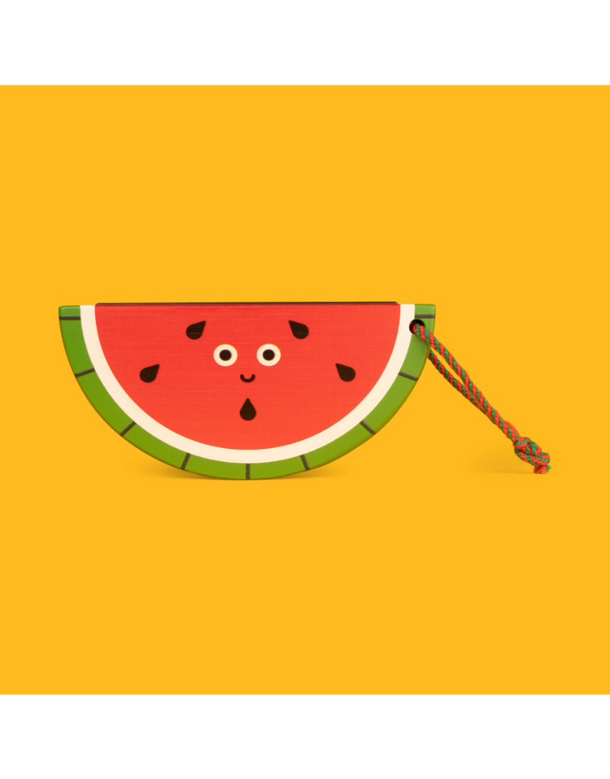 Wooden fruit harmonica by isAlbi held by a child, showcasing its colorful design and compact size for kids' musical play.