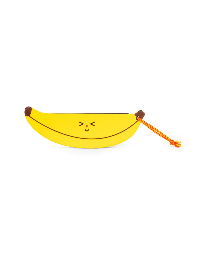 Wooden fruit harmonica by isAlbi held by a child, showcasing its compact design and natural wood finish.