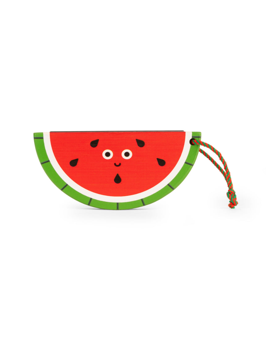 Wooden fruit harmonica by isAlbi held by a child, showcasing its colorful fruit-shaped design and compact size for kids.