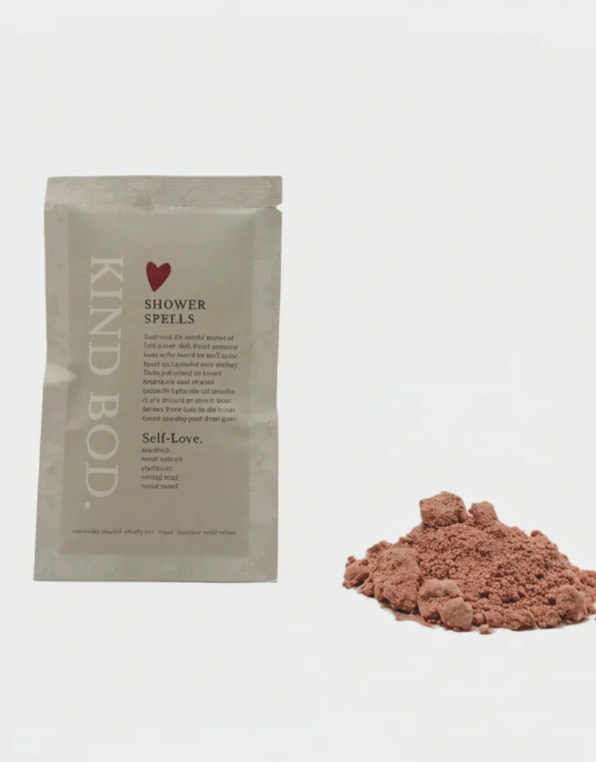 Kind Bod Shower Spells shower bomb dissolving in water, showcasing a colorful, calming bath product designed for relaxation.
