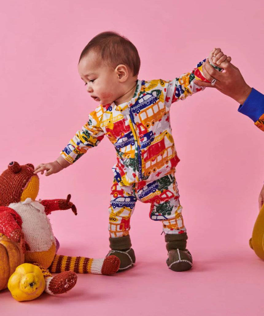 Kip & Co Big Wheels organic long sleeve zip romper for babies in playful wheel pattern, soft and comfy baby clothing.