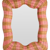 Kip & Co Guava Stripe Rattan Wall Mirror with round shape and woven rattan frame, hanging on a wall.