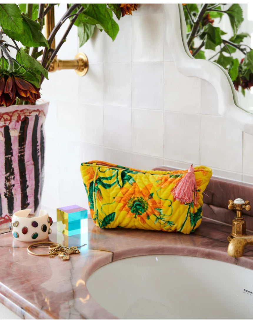 Kip & Co Passiona velvet toiletry bag in vibrant pink with elegant design, perfect for storing personal accessories.