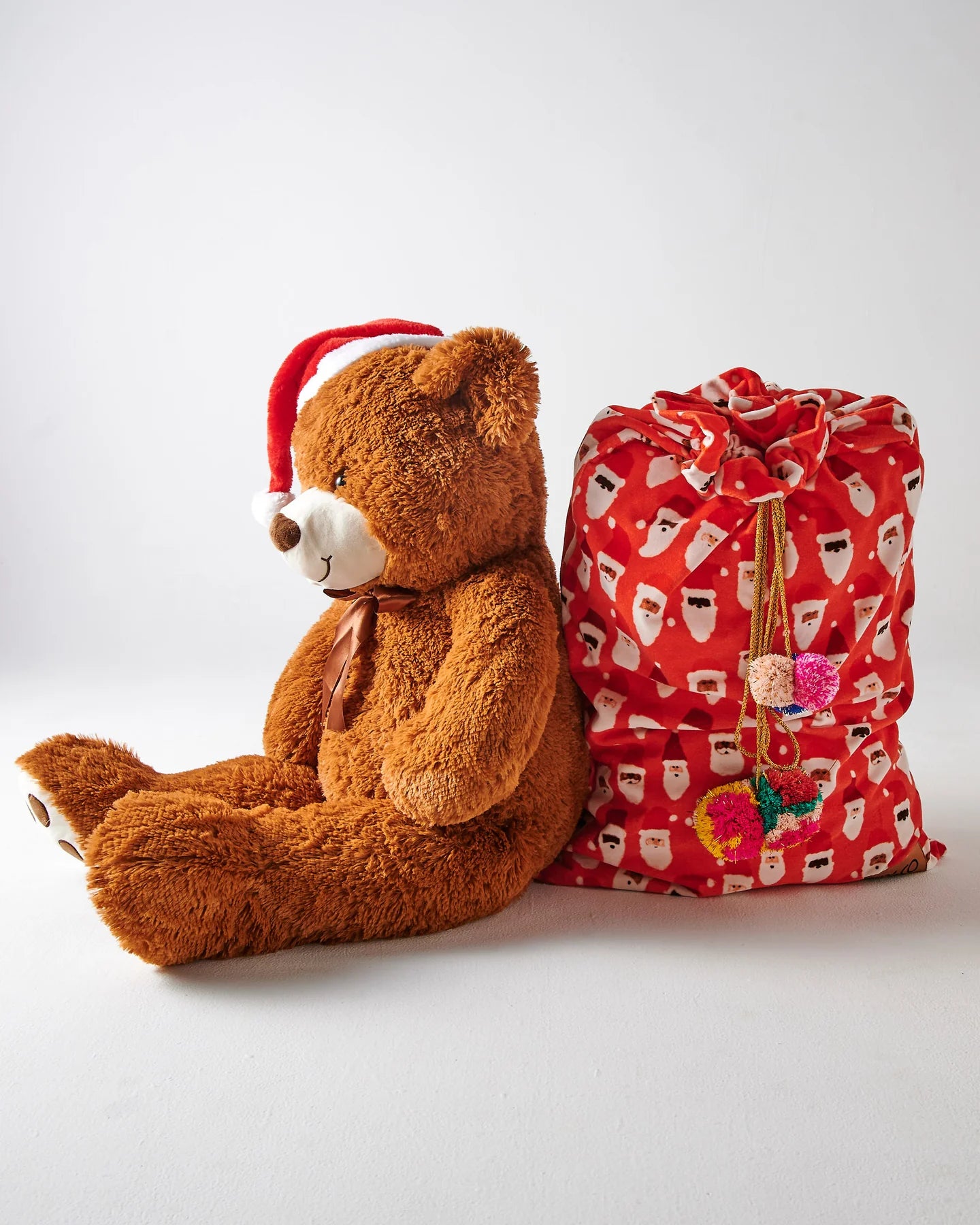 Kip & Co red velvet Santa sack with "HoHoHo" lettering, Christmas holiday gift bag, soft fabric and festive design.