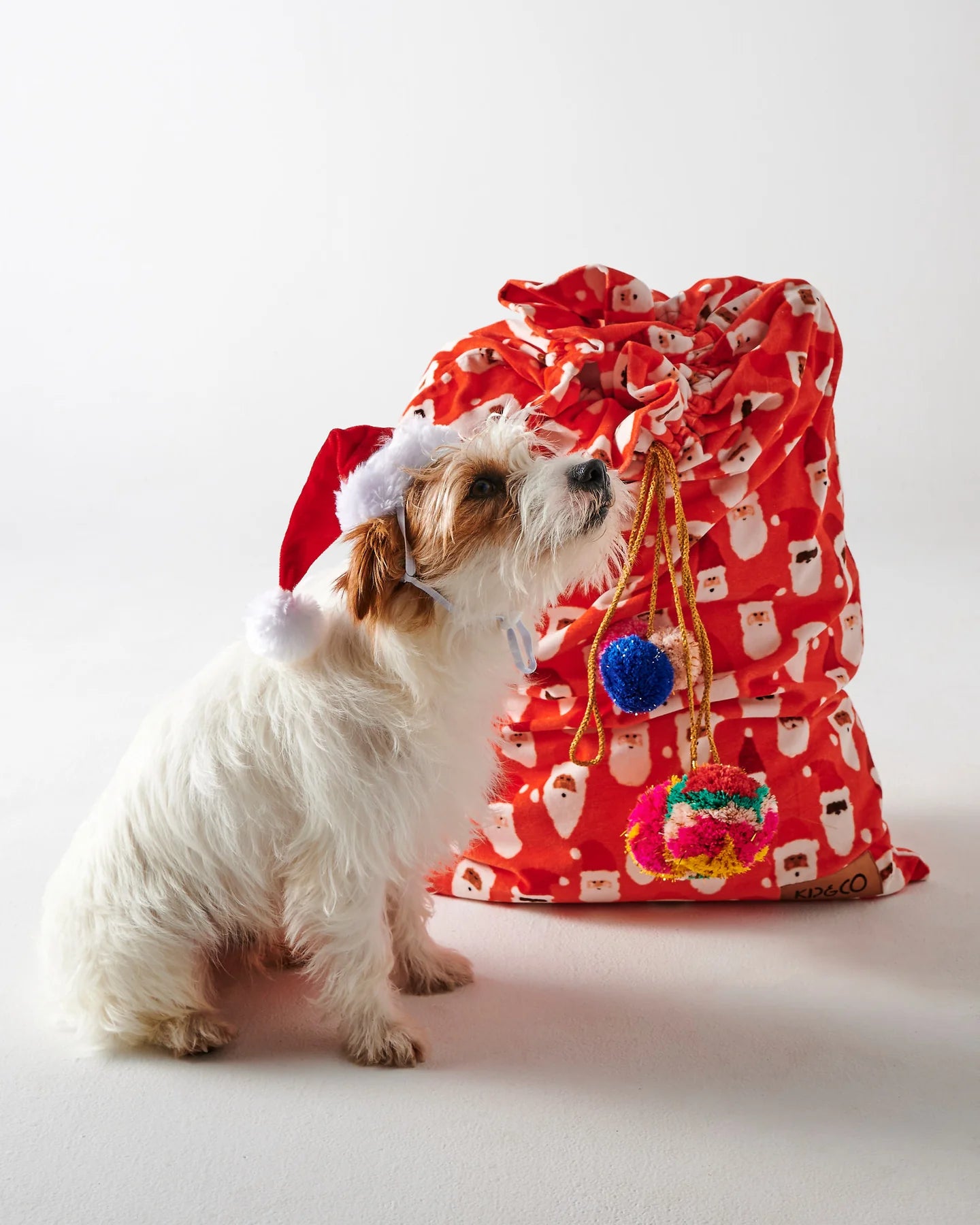 Red velvet Santa sack by Kip & Co with "HoHoHo" design, perfect for Christmas gift wrapping and holiday decor.