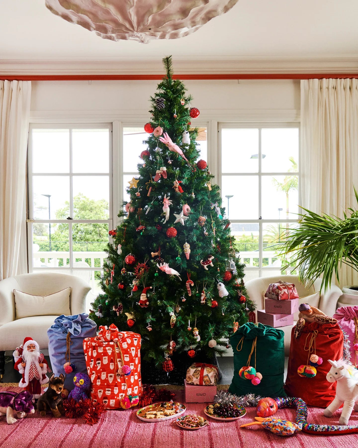 Kip & Co red velvet Santa Sack with HoHoHo lettering, festive Christmas holiday decor for gift wrapping and celebration.