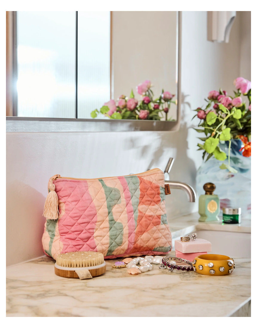Kip & Co Sun Soaked quilted cotton toiletry purse with colorful floral pattern and zipper closure.