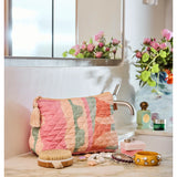 Kip & Co Sun Soaked quilted cotton toiletry purse with colorful floral pattern and zipper closure.