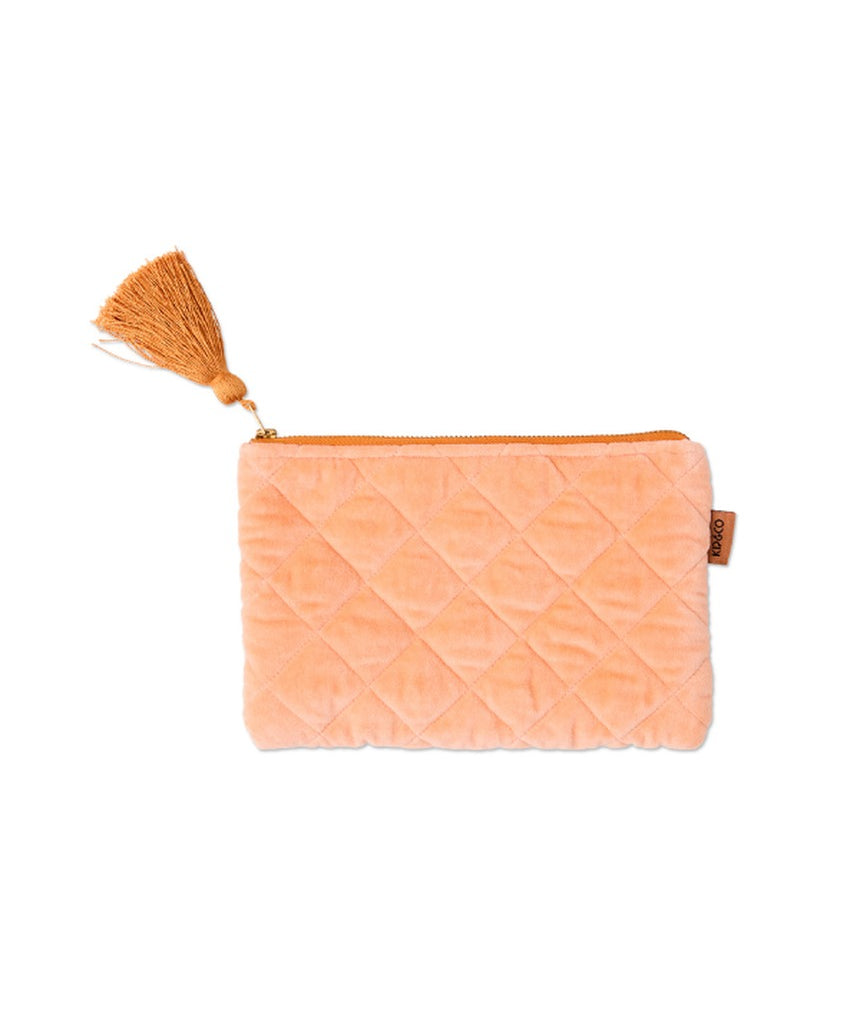 Kip&Co velvet cosmetics purse in vibrant melon color with a soft, textured fabric and compact design for makeup storage.