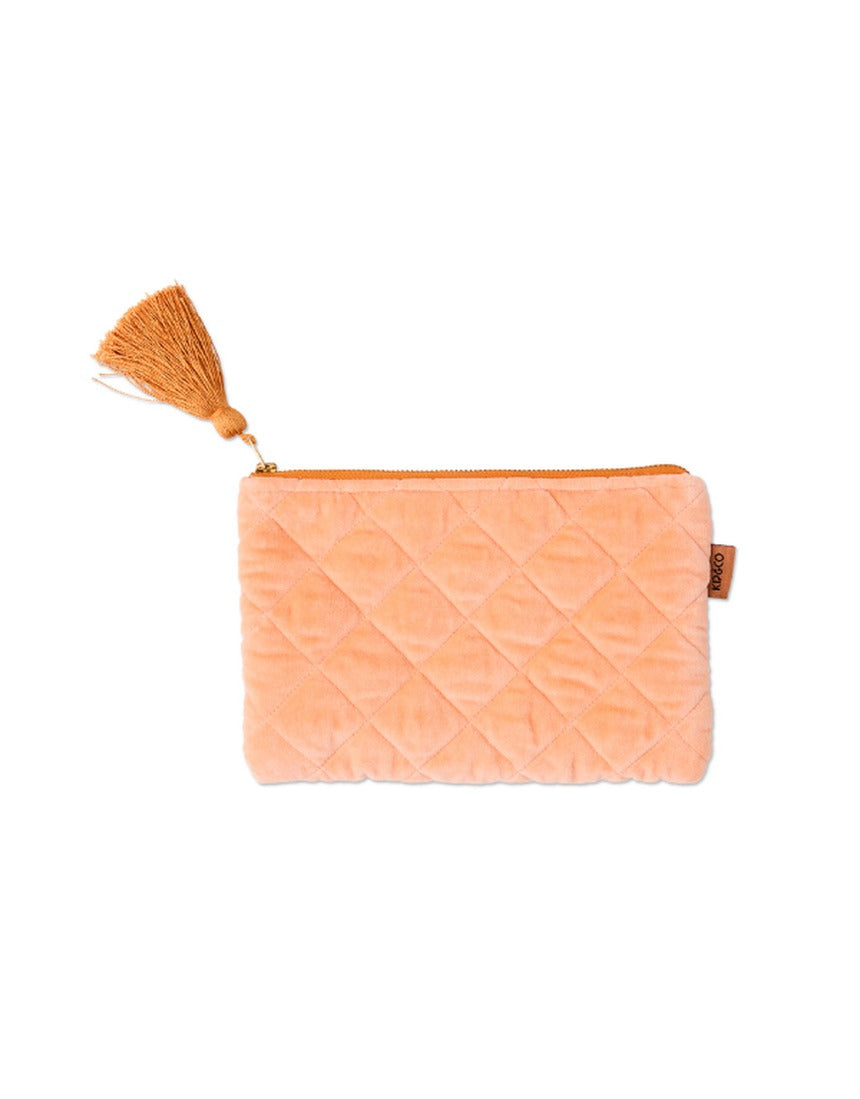 Kip&Co velvet cosmetics purse in vibrant melon color with a soft, textured fabric and compact design for makeup storage.