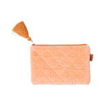 Kip&Co velvet cosmetics purse in vibrant melon color with a soft, textured fabric and compact design for makeup storage.
