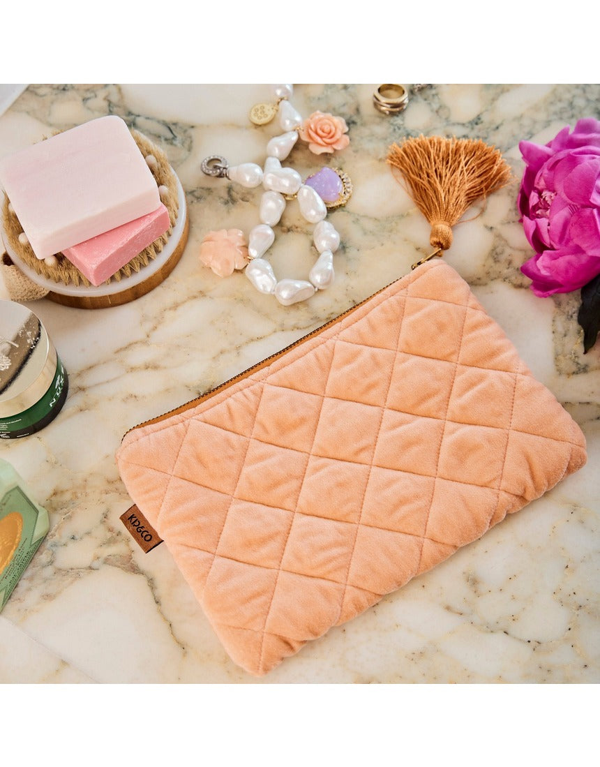 Kip&Co velvet cosmetics purse in vibrant melon color, featuring a soft, plush texture and compact design for makeup essentials.