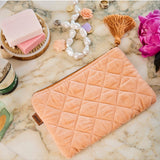 Kip&Co velvet cosmetics purse in vibrant melon color, featuring a soft, plush texture and compact design for makeup essentials.