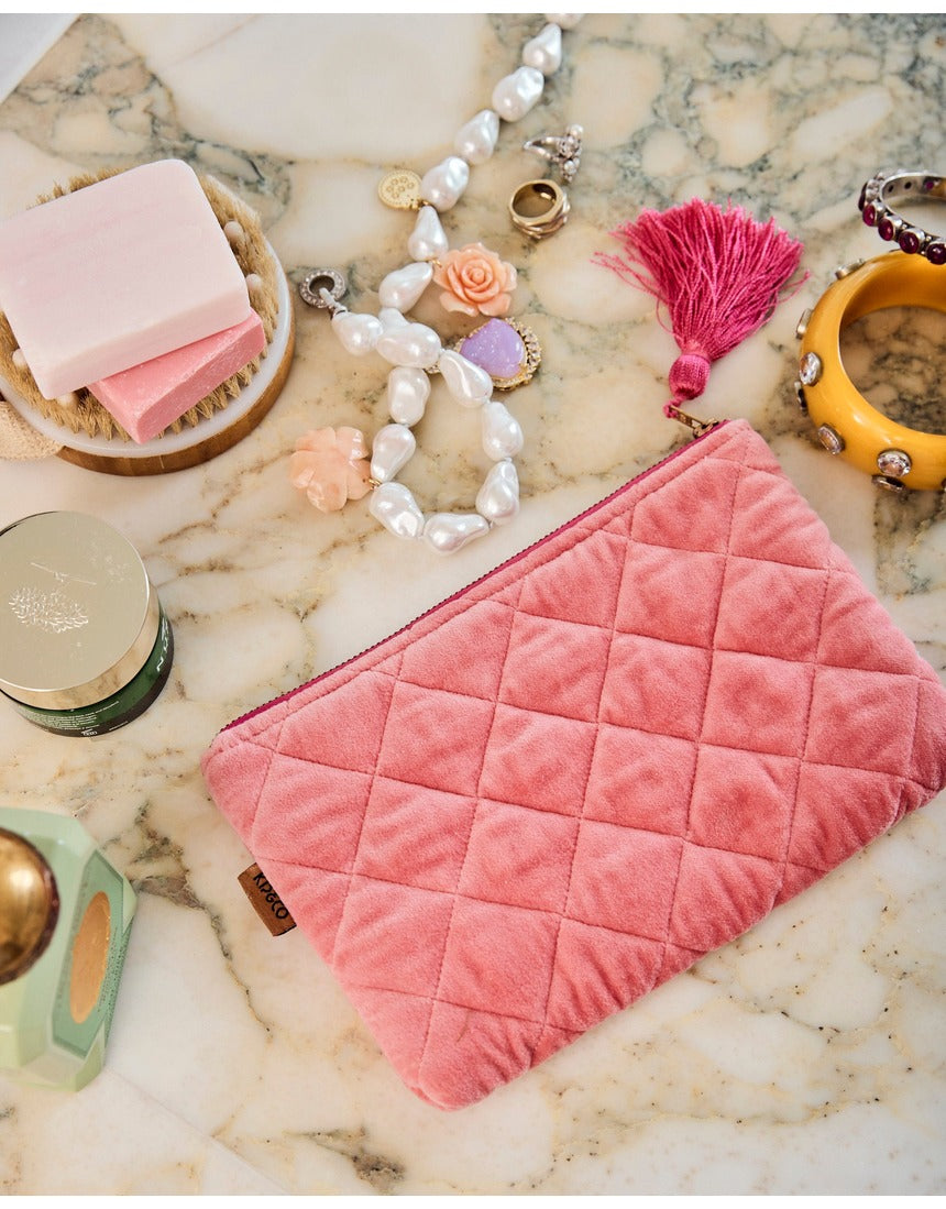 Kip&Co velvet cosmetics purse in strawberry color, featuring a soft fabric exterior and compact design for makeup storage.