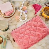 Kip&Co velvet cosmetics purse in strawberry color, featuring a soft fabric exterior and compact design for makeup storage.