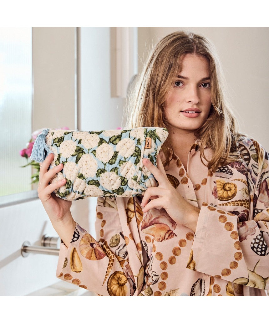 Kip&Co velvet toiletry bag in Hydrangea Blue with zipper closure and soft fabric, perfect for travel storage.