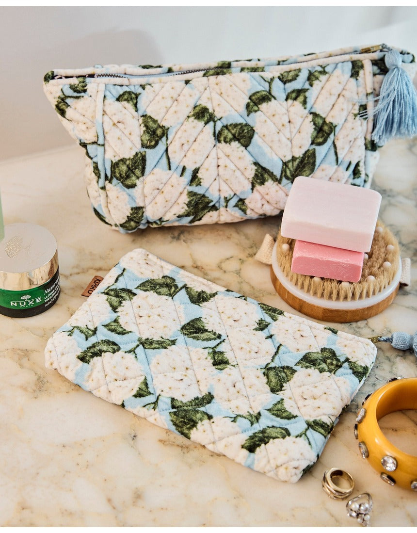 Kip&Co velvet toiletry bag in Hydrangea Blue with floral pattern, soft fabric, and zip closure, ideal for travel storage