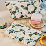 Kip&Co velvet toiletry bag in Hydrangea Blue with floral pattern, soft fabric, and zip closure, ideal for travel storage